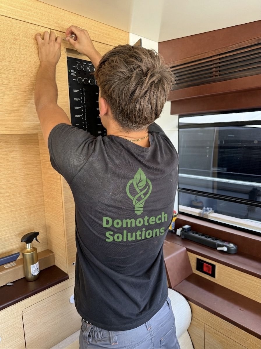 Professional de Domotech treballant en un quadre a bord